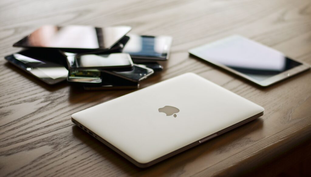 laptop, tablet, phones on the desk